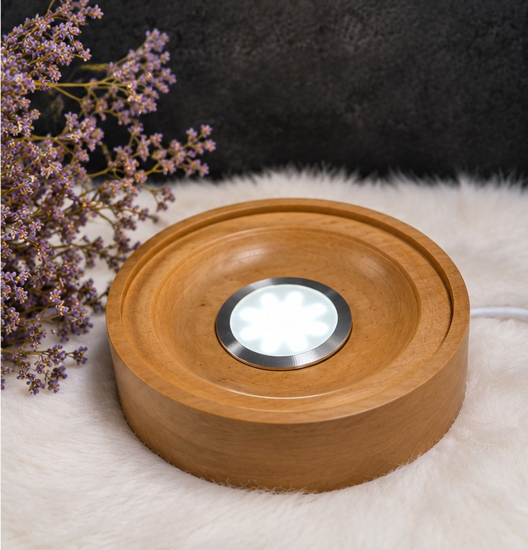 The turned pear-wood base on its own, with its LED